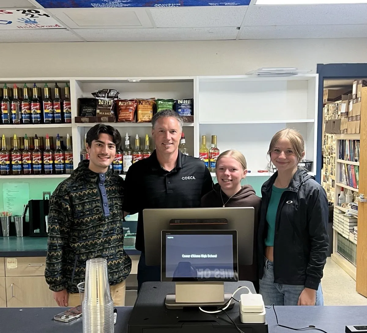 Tony Carrico and the CHS DECA store crew, at the counter where all of it happened.